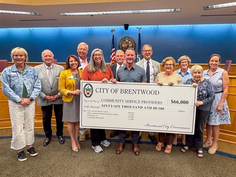 community members receive a check from the city.