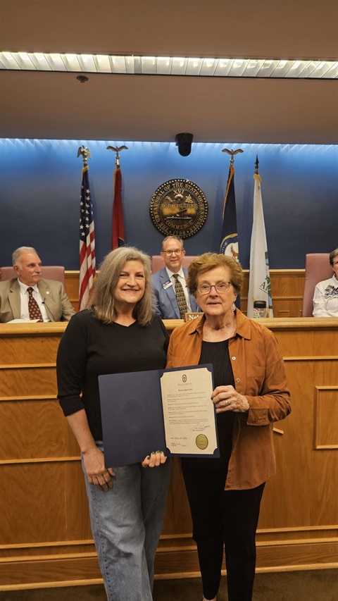 Tree Board member Angela Beaton and Tree Board Chair Lynn Tucker accept the City's proclamation. 