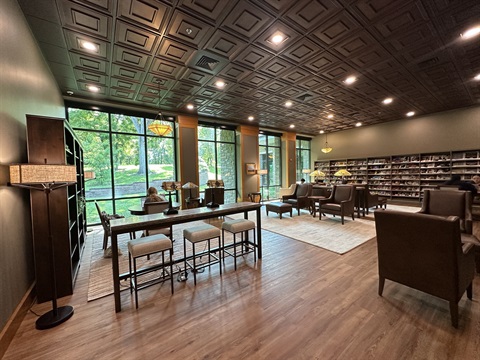 The library's quiet room, featuring featuring glass walls and doors that complement the library's existing architecture, new flooring, fresh paint, enhanced ceiling treatments, updated electrical features, an electric fireplace and comfortable new furnishings.